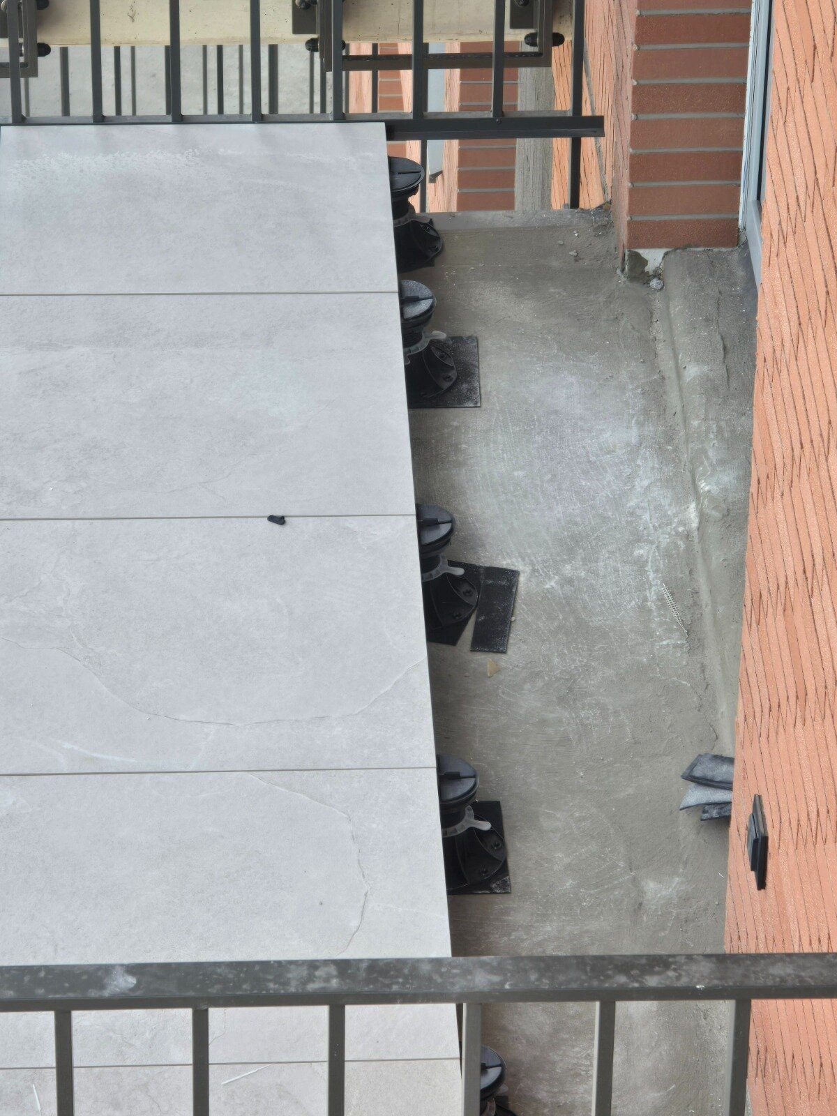 Platten verlegt auf höhenverstellbaren Stelzlagern auf dem Balkon eines Mehrfamilienhauses