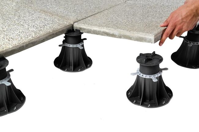 Adjustable pedestals with 5 mm spacers for pavers with laid concrete pavers