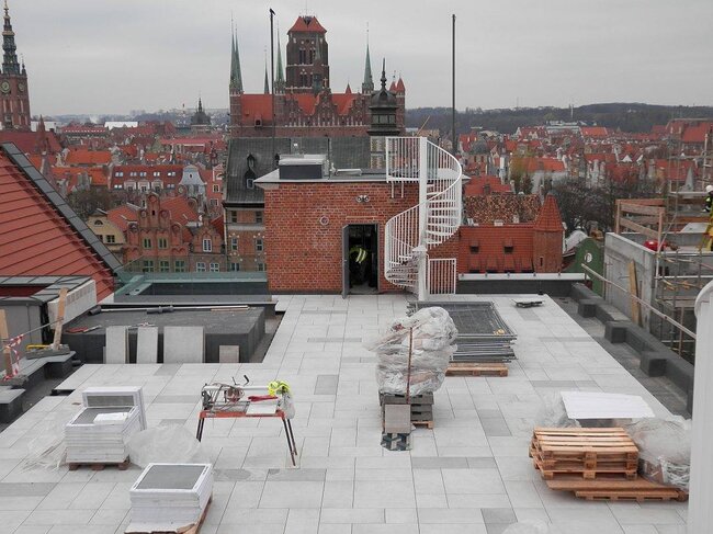 Dachterrasse im Bau mit erhöhter Terrassenplattenfläche auf höhenverstellbaren Stelzlagern.